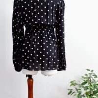 Image of the back of H&M maternity black and cream polka dot maternity wrap top