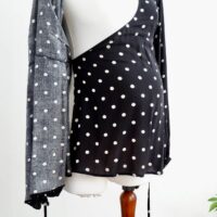 Image of H&M maternity black and cream polka dot maternity wrap top showing the inside wrap feature.