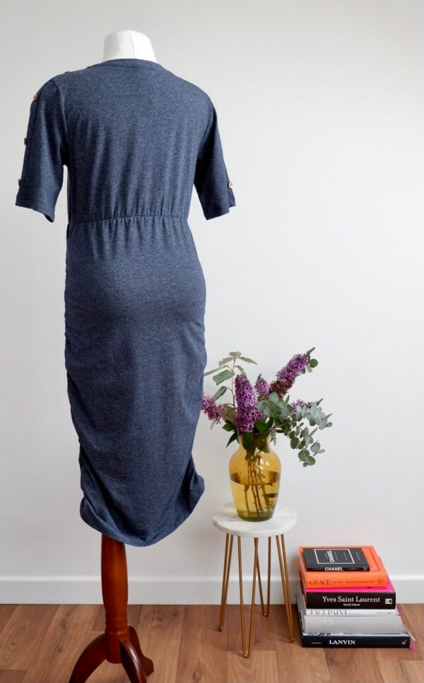 Back image of dark blue maternity dress with short sleeves on a mannequin