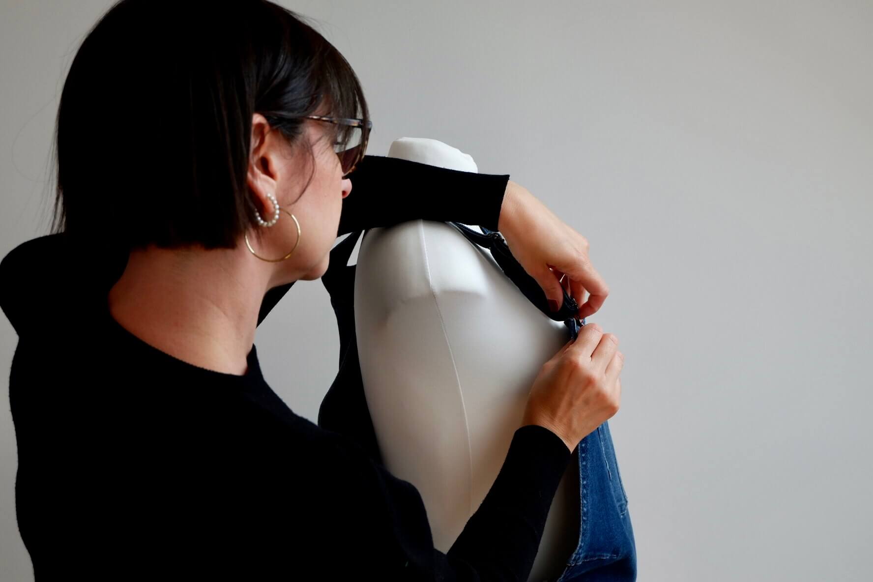 Image of Jo Leggiero, founder of Mother Dragon adjusting the top of maternity dungarees on a mannequin