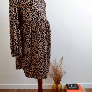 Animal print maternity dress on a mannequin against a white wall