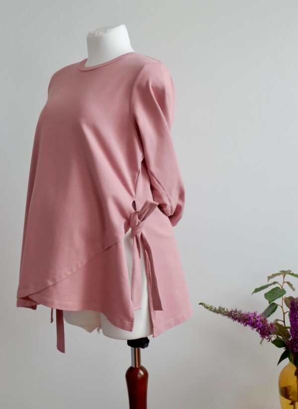 Image of side of dusty pink maternity sweatshirt with side ties on a mannequin