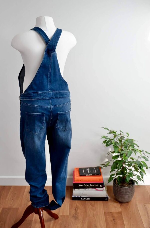 Image of back Seraphine maternity dungarees on a mannequin in a white wall studio
