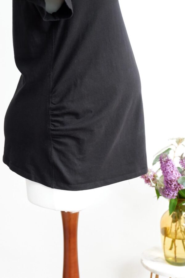Side view of black maternity t-shirt on a maternity mannequin