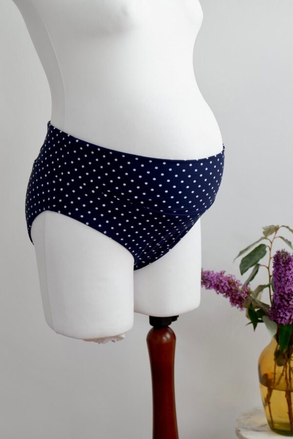 Blue and white polka dot maternity swim bikini briefs on a mannequin