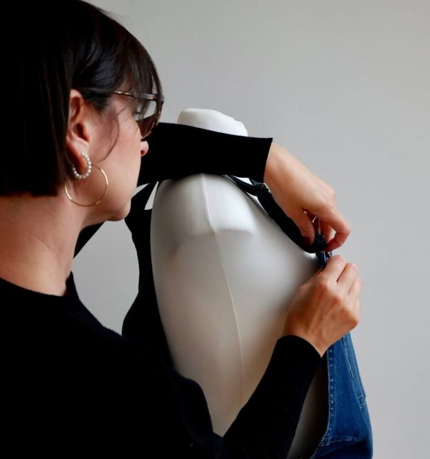 Image of Jo Leggiero, founder of Mother Dragon adjusting the top of maternity dungarees on a mannequin